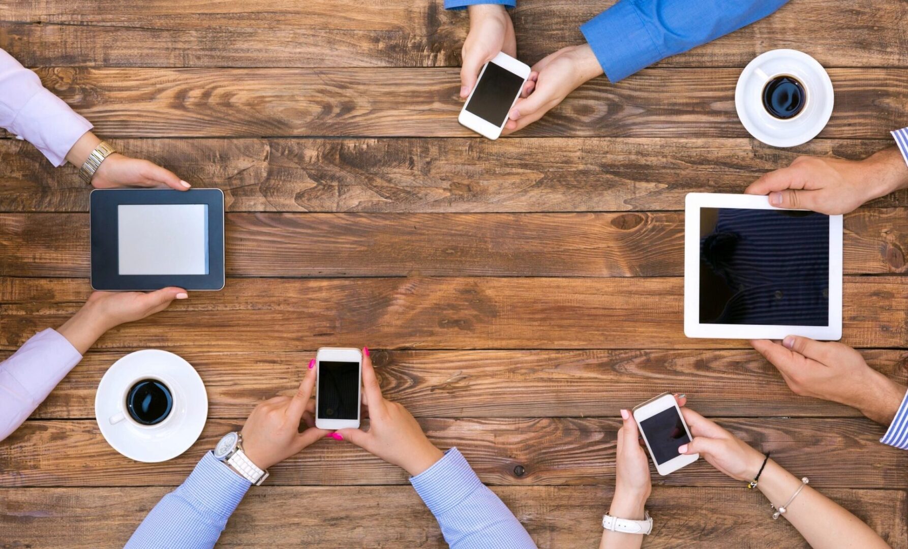 people holding smartphones and tablet